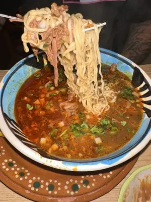 Los Famosos Cocina Mexicana signature dishes Carne en su JugoBirria RamenChilaquiles con Huevo